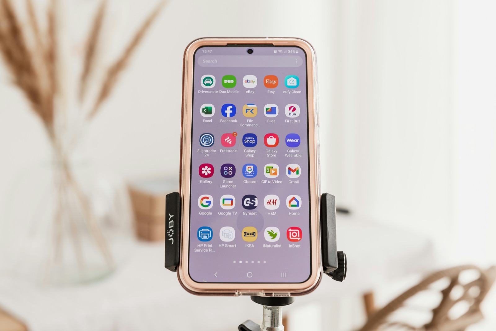 A smartphone mounted on a tripod for recording